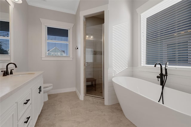 full bathroom with toilet, vanity, a freestanding bath, a stall shower, and crown molding