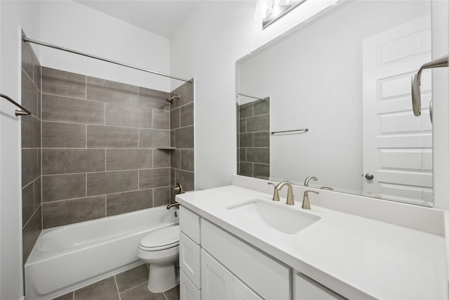 bathroom featuring vanity, tile patterned flooring, shower / tub combination, and toilet