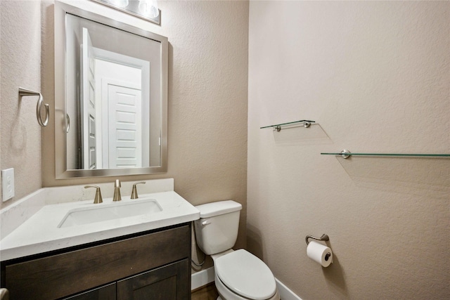 bathroom with toilet and vanity