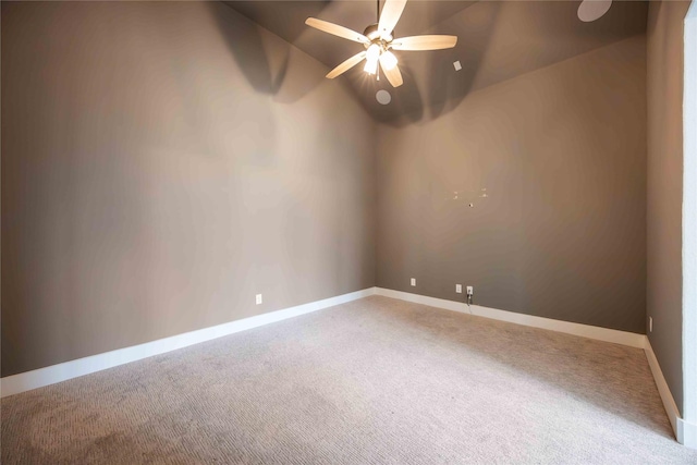 unfurnished room with baseboards, vaulted ceiling, ceiling fan, and light carpet