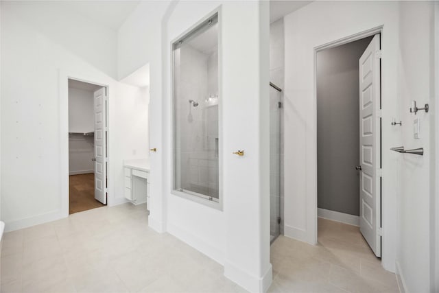 corridor featuring baseboards and light tile patterned floors