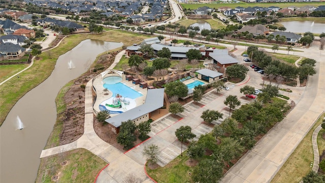 birds eye view of property with a water view and a residential view