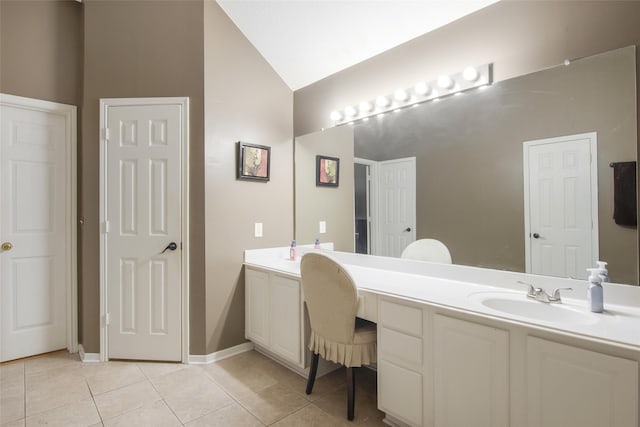 bathroom with lofted ceiling, tile patterned flooring, baseboards, and vanity