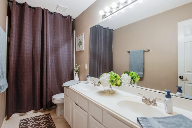 full bath featuring double vanity, tile patterned flooring, a sink, and visible vents