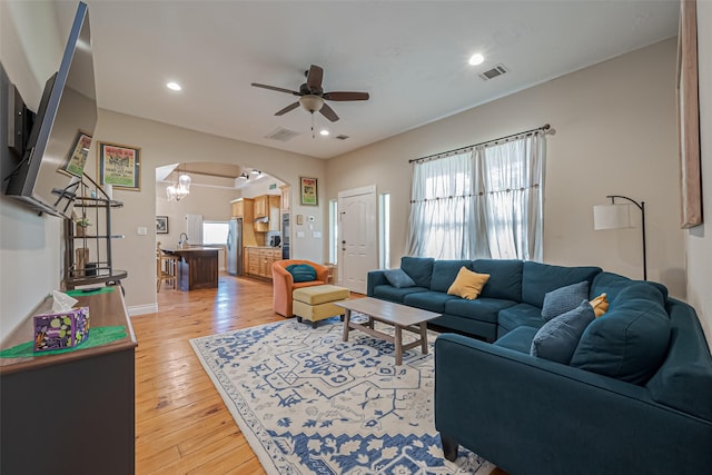 living room with visible vents, arched walkways, a ceiling fan, wood-type flooring, and recessed lighting