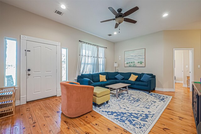 living area featuring light wood finished floors, visible vents, and recessed lighting