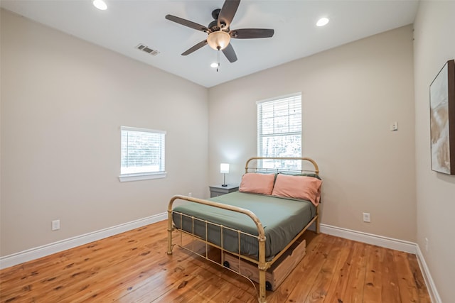 bedroom with visible vents, light wood finished floors, and multiple windows