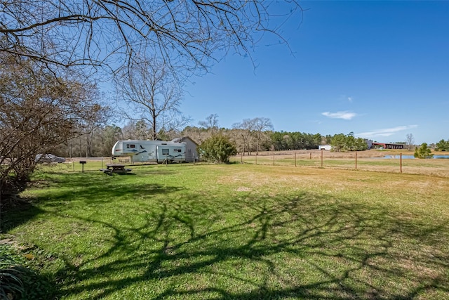 view of yard featuring a rural view and fence