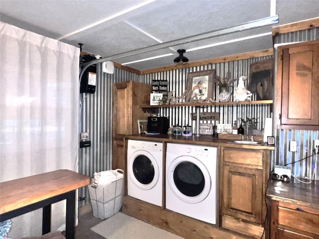 laundry area with a garage, a sink, washing machine and dryer, indoor wet bar, and laundry area