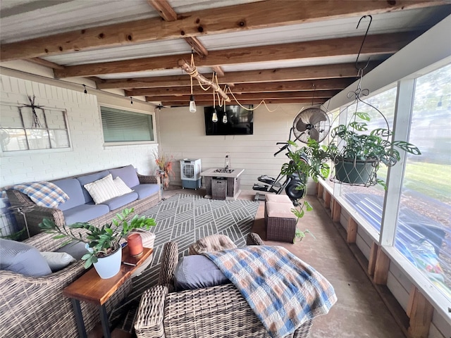 sunroom featuring beamed ceiling