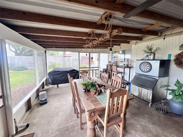 sunroom featuring beam ceiling