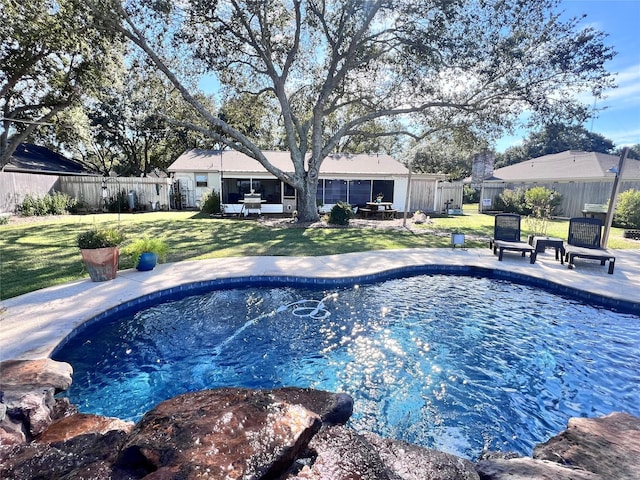 view of swimming pool with a fenced in pool, a lawn, a fenced backyard, and a patio area