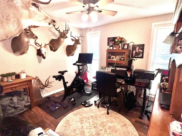 office area with baseboards and ceiling fan