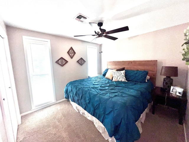 bedroom featuring visible vents, baseboards, carpet, and ceiling fan