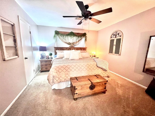 carpeted bedroom with baseboards and a ceiling fan