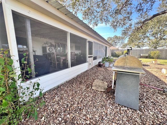 entry to storm shelter featuring fence