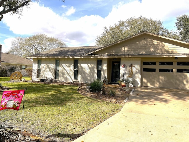 ranch-style home featuring a garage, a front yard, brick siding, and driveway