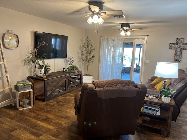 living area with a ceiling fan, wood finished floors, and visible vents