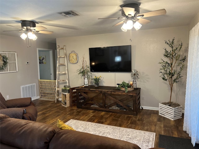 living room with wood finished floors, visible vents, and ceiling fan