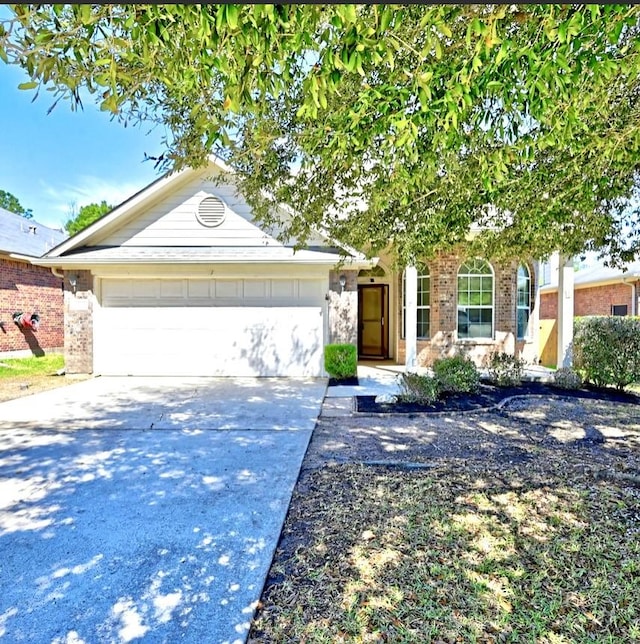 ranch-style house featuring concrete driveway, brick siding, and an attached garage