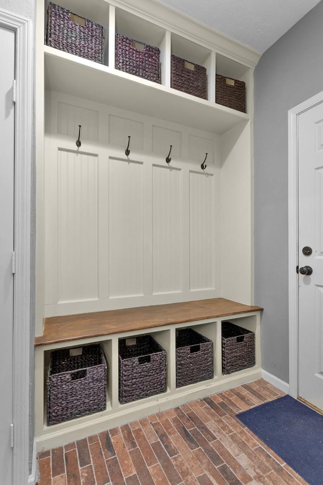 590 Edgewood Dr, Montgomery, TX 77356 - mudroom featuring brick flooring and baseboards