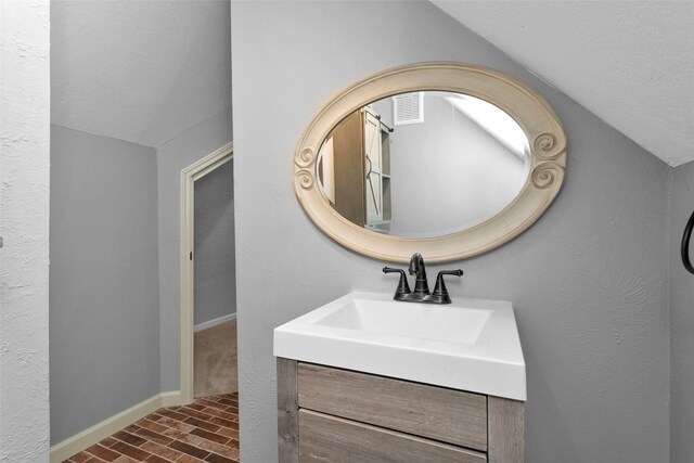 590 Edgewood Dr, Montgomery, TX 77356 - bathroom with lofted ceiling, vanity, and wood finished floors