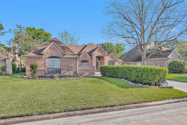 590 Edgewood Dr, Montgomery, TX 77356 - view of front facade with brick siding, a front lawn, and a shingled roof