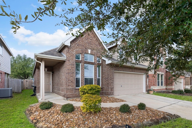 view of front of home with a garage, driveway, brick siding, and fence