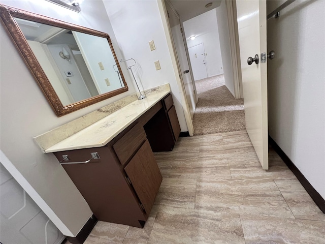 bathroom with vanity and baseboards