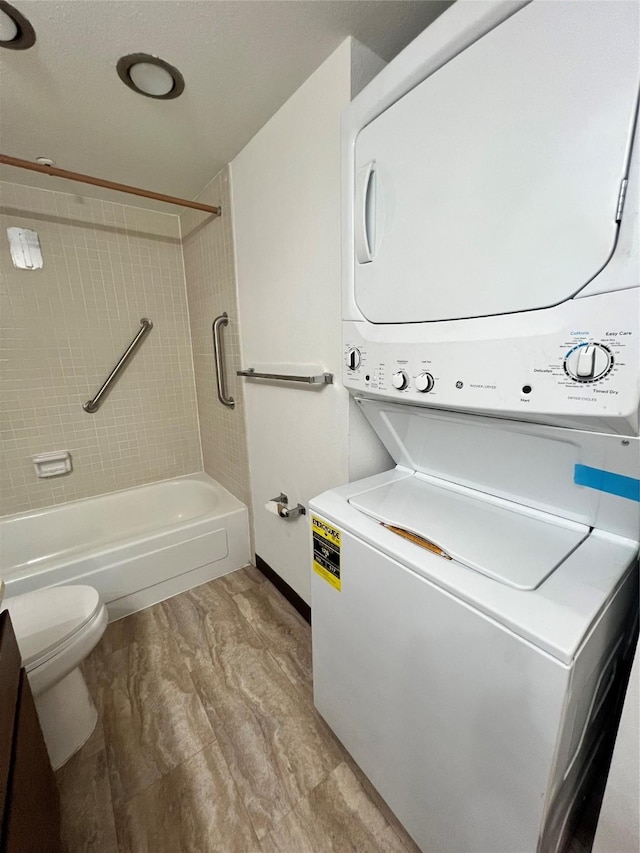 laundry area with laundry area and stacked washer / drying machine