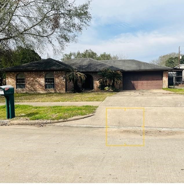 13610 Lynnwood Ln, Sugar Land, TX 77498 - ranch-style house with a shingled roof, concrete driveway, and brick siding