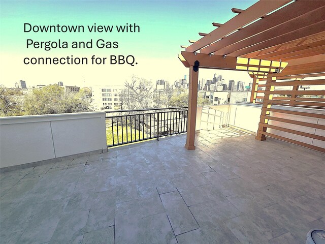 view of patio / terrace featuring a view of city and a pergola