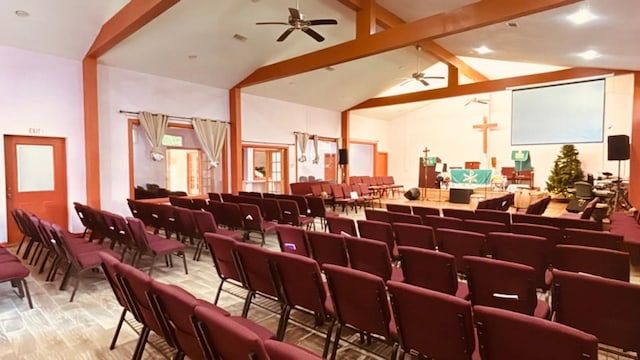 interior space featuring high vaulted ceiling, wood finished floors, a ceiling fan, and beamed ceiling