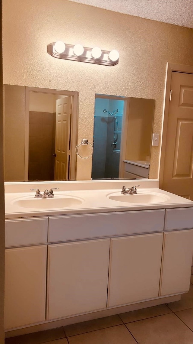 bathroom with double vanity, tile patterned flooring, and a sink