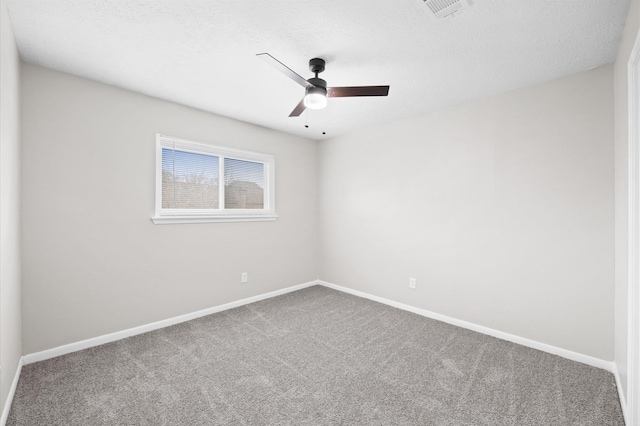 carpeted empty room featuring visible vents, a textured ceiling, baseboards, and a ceiling fan