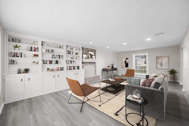 3610 Mossville Ct, Houston, TX 77068 - living area with light wood-type flooring, recessed lighting, a brick fireplace, and baseboards
