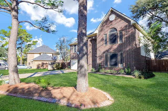 view of front facade featuring brick siding, a front yard, and fence