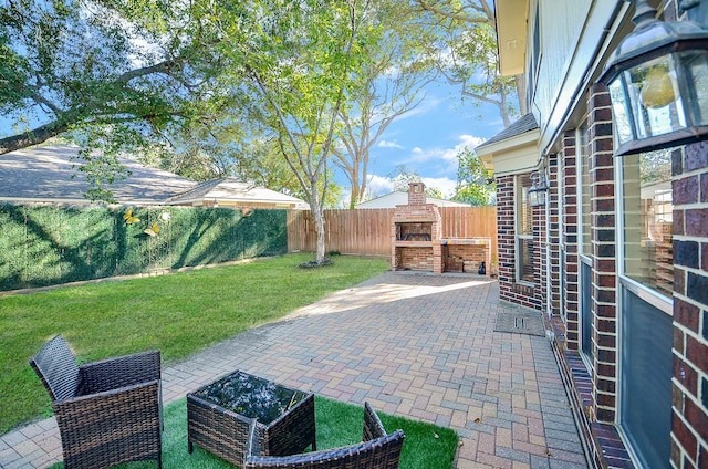 view of patio with a fenced backyard and an outdoor fireplace