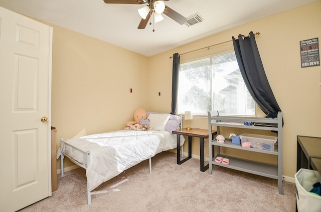 bedroom with baseboards, ceiling fan, visible vents, and light colored carpet