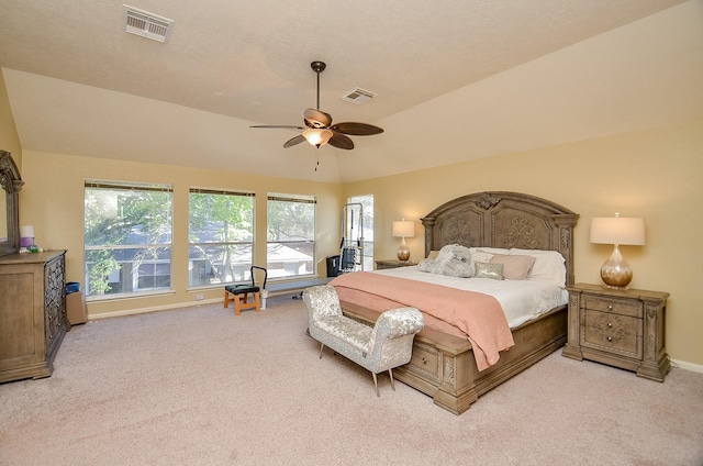 bedroom featuring light carpet, visible vents, and vaulted ceiling