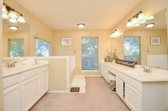 full bath featuring a sink, two vanities, and baseboards