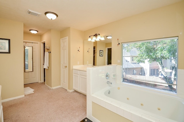 full bathroom with a whirlpool tub, visible vents, vanity, and baseboards