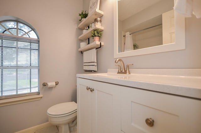 bathroom featuring a healthy amount of sunlight, curtained shower, toilet, and vanity