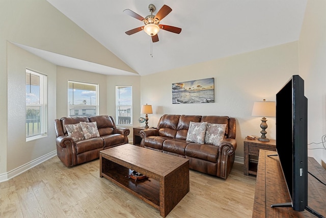 living area featuring a ceiling fan, light wood-type flooring, vaulted ceiling, and baseboards