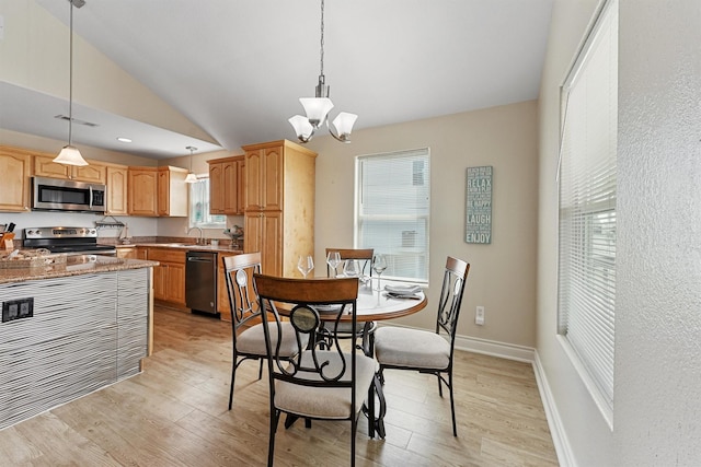 dining area with a chandelier, light wood-style flooring, visible vents, baseboards, and vaulted ceiling