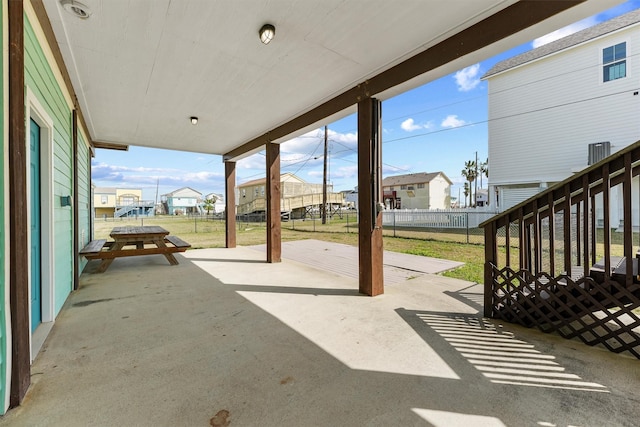 view of patio featuring a residential view and fence