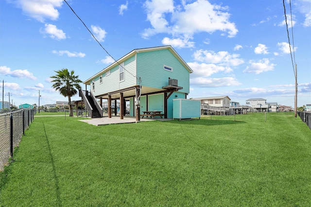 back of property featuring a patio area, a fenced backyard, and a lawn