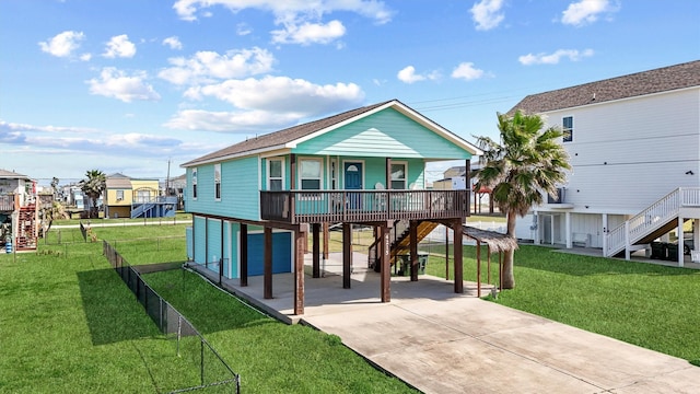 exterior space featuring driveway, stairway, fence, a yard, and a carport