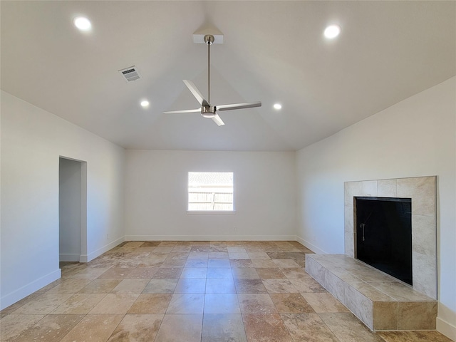 unfurnished living room featuring lofted ceiling, ceiling fan, a fireplace, visible vents, and baseboards