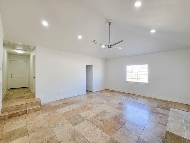 empty room featuring attic access, lofted ceiling, ceiling fan, and baseboards